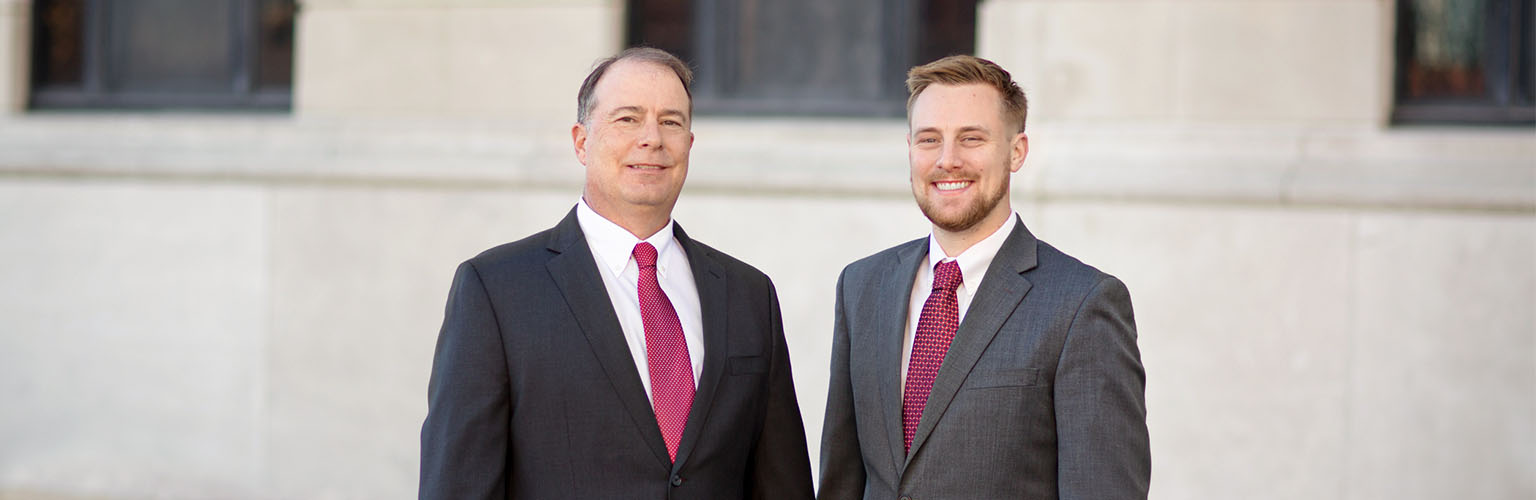 Chris and Cale Spangler standing in front of the Pettis County Courthouse